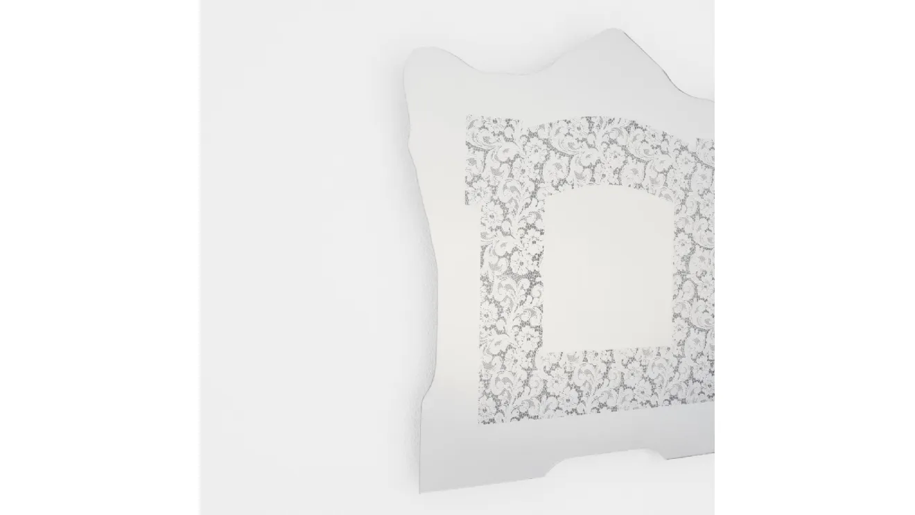 Spizzo mirror with lace insert reflecting from Glas Italia.