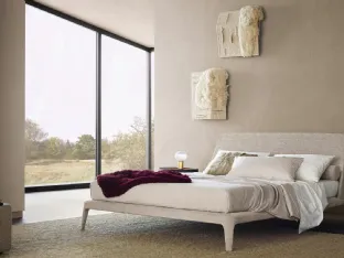 Poliform's Kelly bed upholstered in Naxos Sabbia fabric.