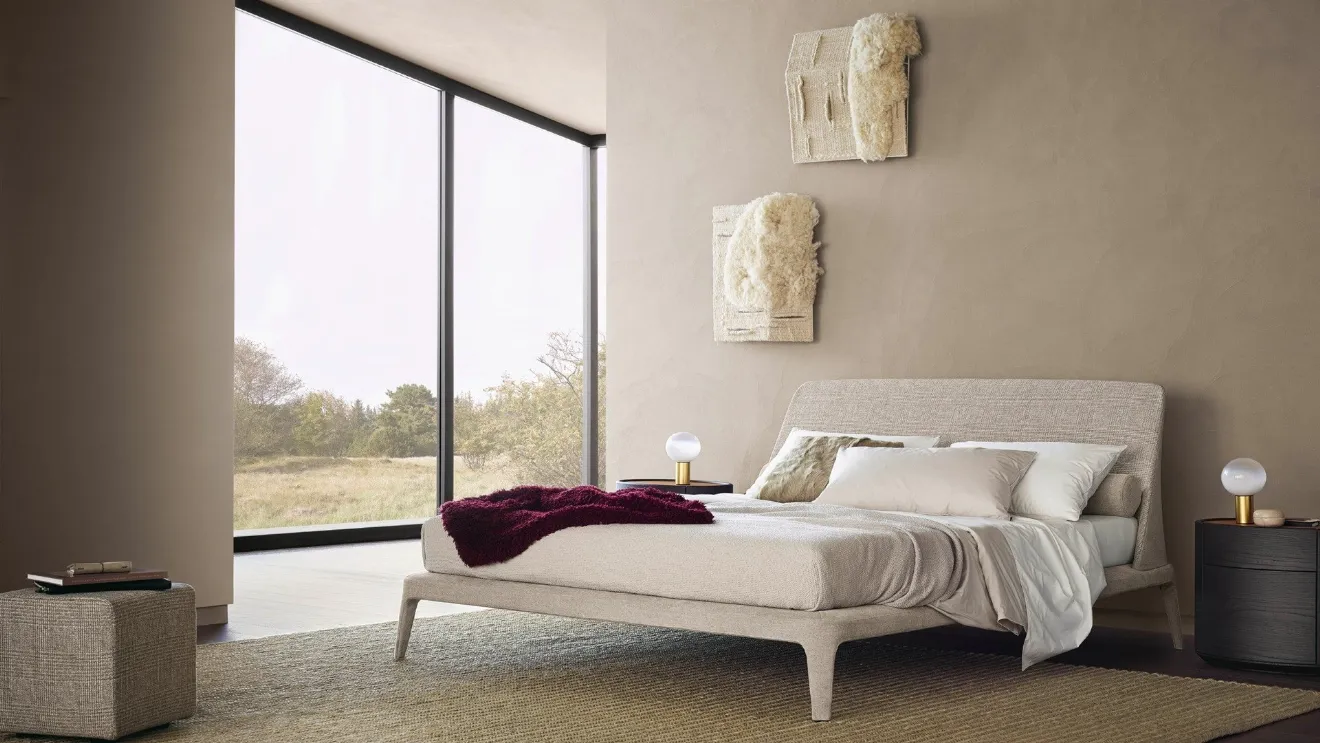 Poliform's Kelly bed upholstered in Naxos Sabbia fabric.
