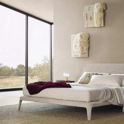 Poliform's Kelly bed upholstered in Naxos Sabbia fabric.