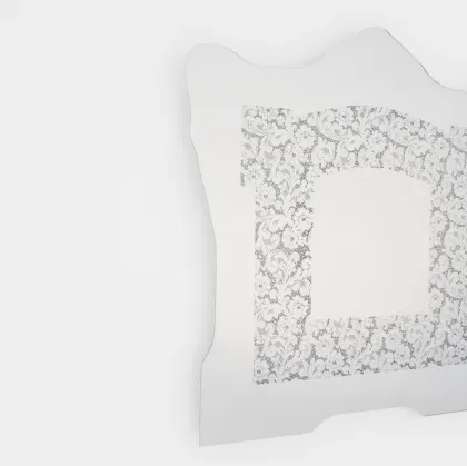 Spizzo mirror with lace insert reflecting from Glas Italia.