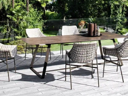 Padded steel armchair and Summer Set steel table by Varaschin